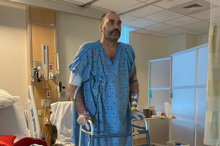 Scot Pollard at the hospital standing with a walker