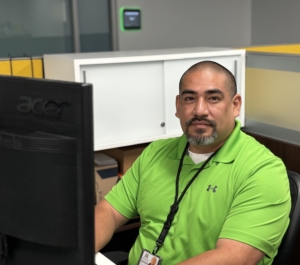 A man sitting at a computer desk.