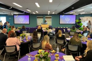 A conference room filled with guests for award ceremony.