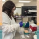 A woman in a lab coat testing samples.